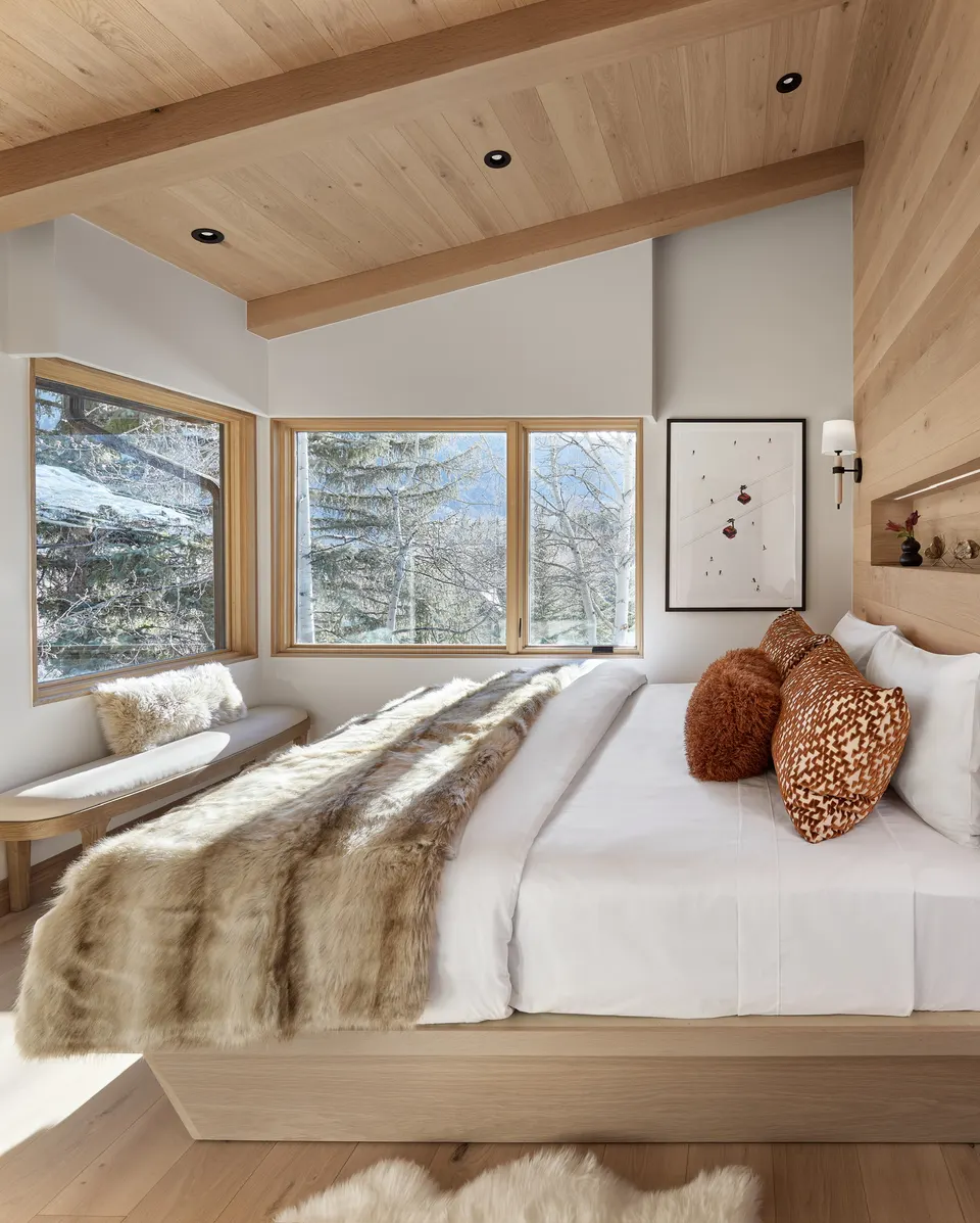 Bedroom corner with pale white oak floor and mountain views through the windows