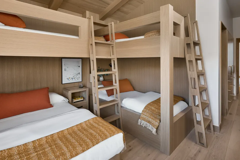 Bunk room with built-in oak bunks over a pale white oak floor