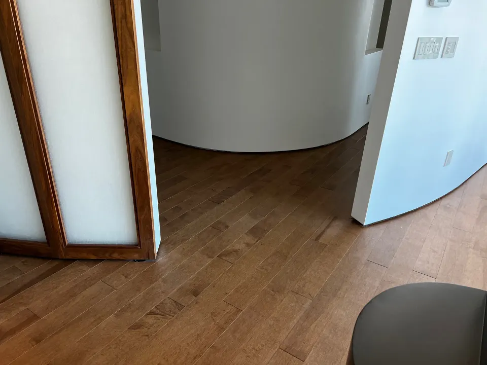 Close-up of hardwood floor boards cut to follow a curved wall