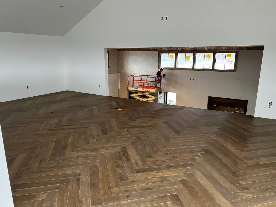 Dark herringbone floor through a large open space
