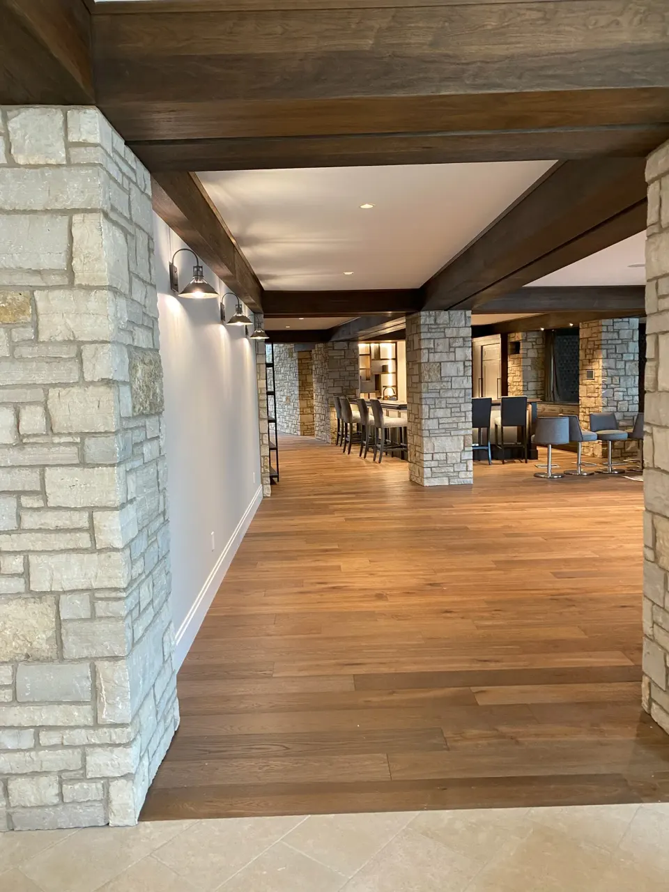 Walnut hardwood in an entertaining space with a stone bar