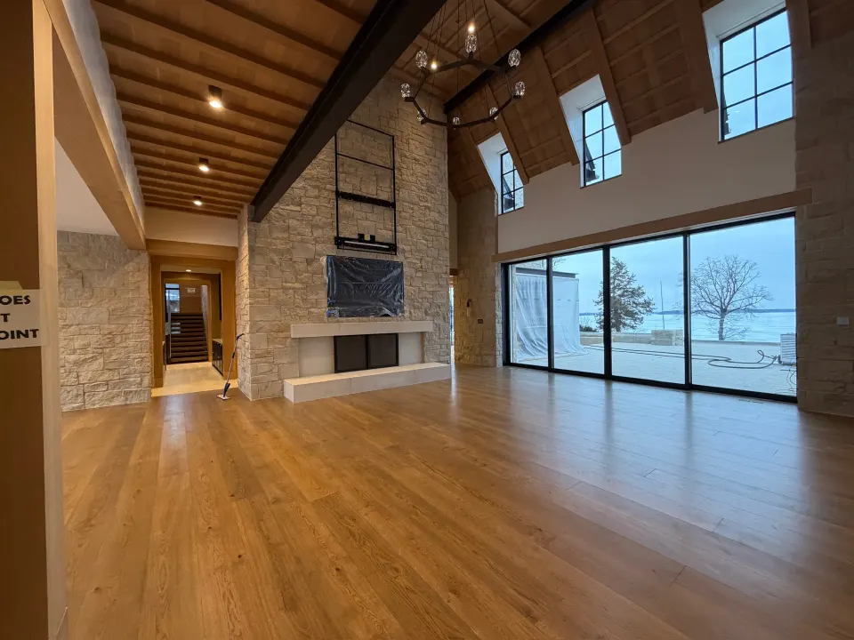 Wide-plank hardwood in a vaulted lakefront great room