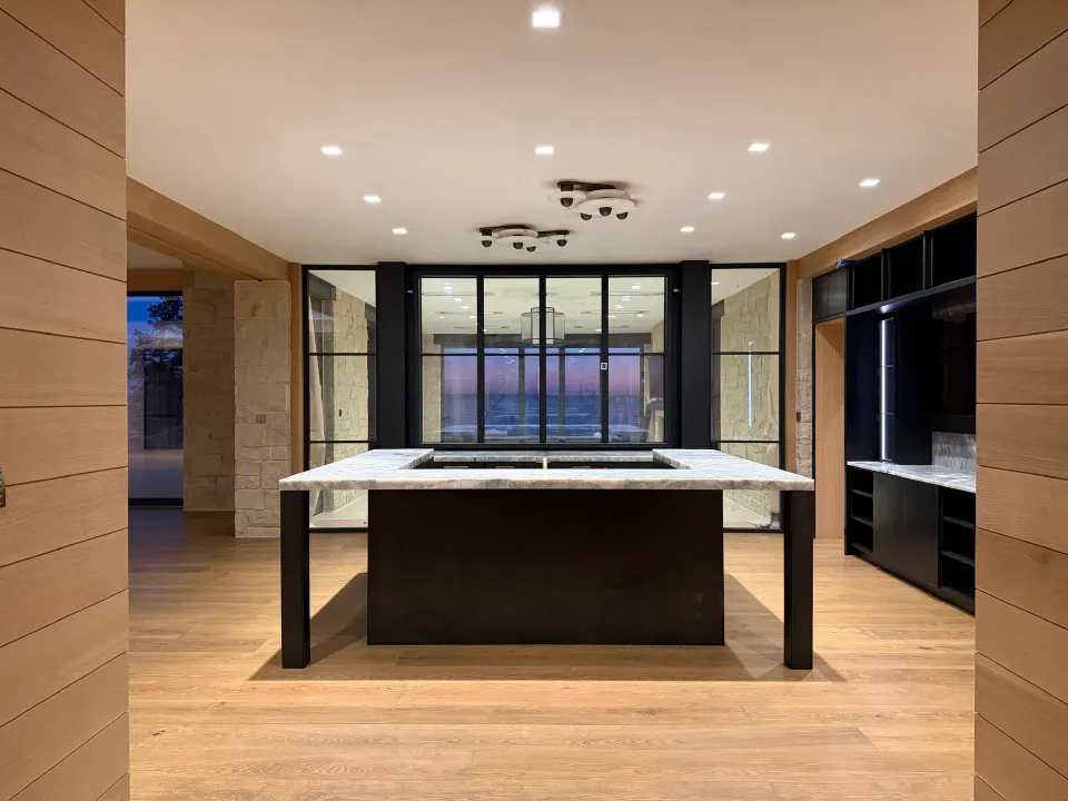 Oak floor under a marble island kitchen at twilight