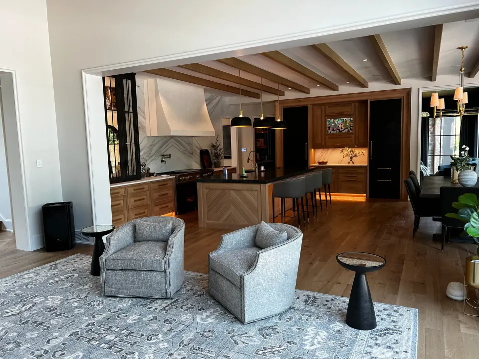 Wide-plank oak through an open living room and kitchen