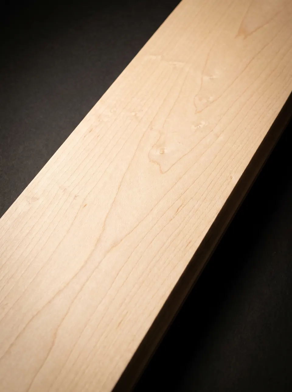 Close view of a hard maple plank showing pale cream color and fine closed grain
