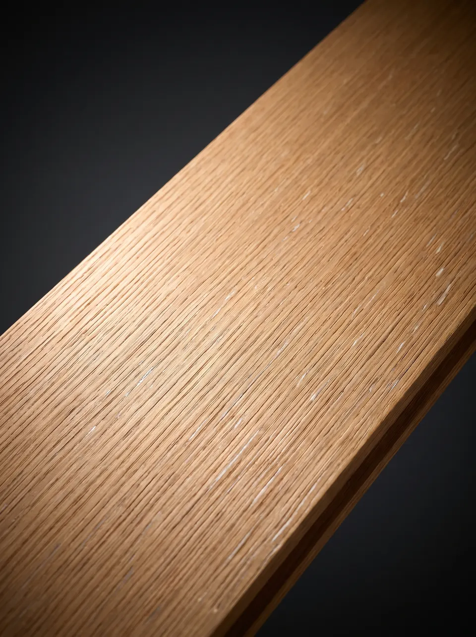 Close view of a white oak plank showing tan color and tight straight grain