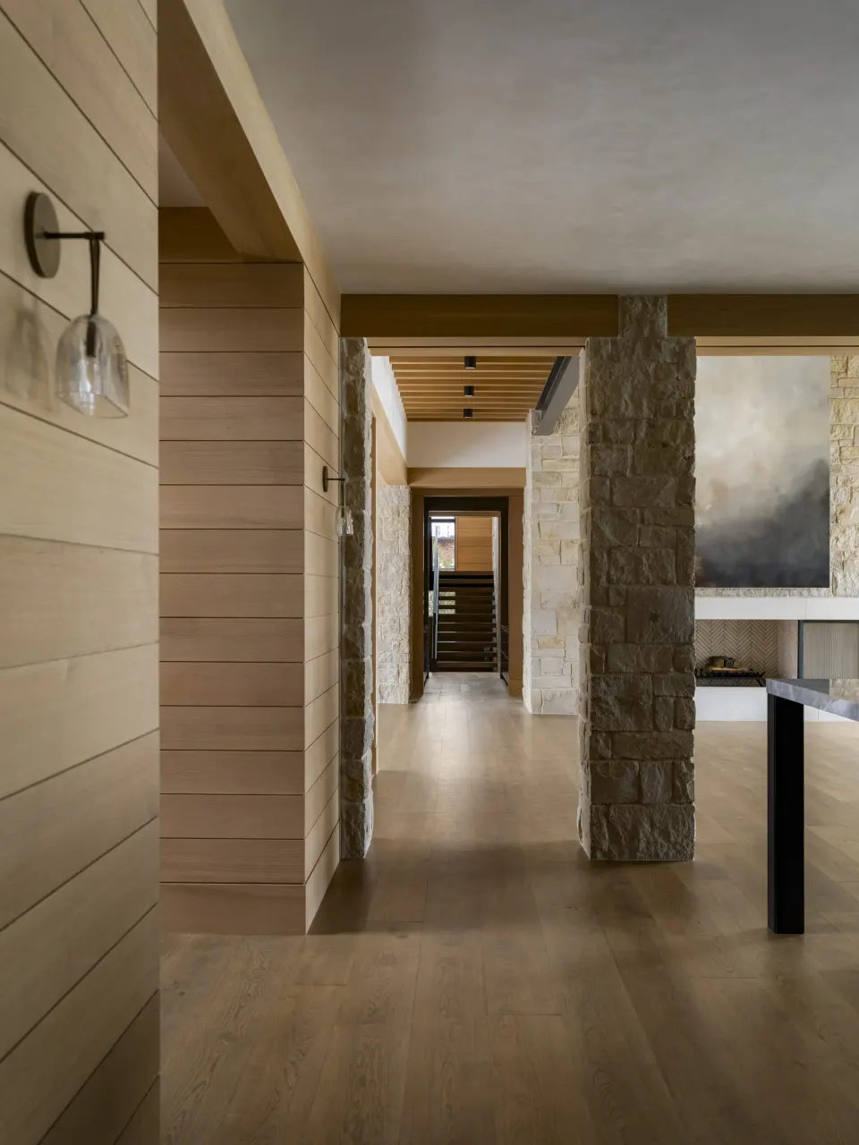 White oak shiplap hallway beside a stone column