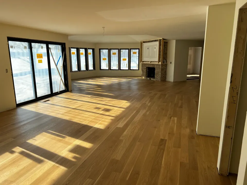 White oak plank flooring installed in a living room still under construction